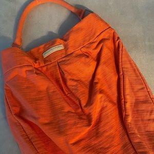 Pale orange summer bag. Inside pockets. Great for the beach or traveling.